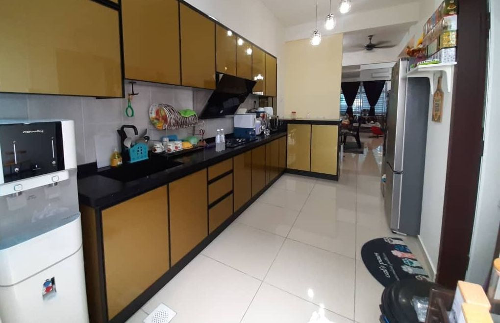 A gold gloss kitchen in a lived-in home with pendant lights, a water dispenser and a long worktop run.