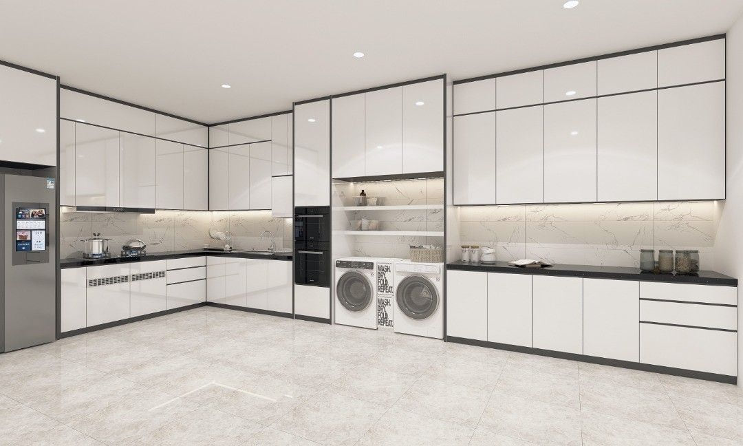 A white L-shaped kitchen with a tall oven housing, two front-load washing machines and a marble-look backsplash.